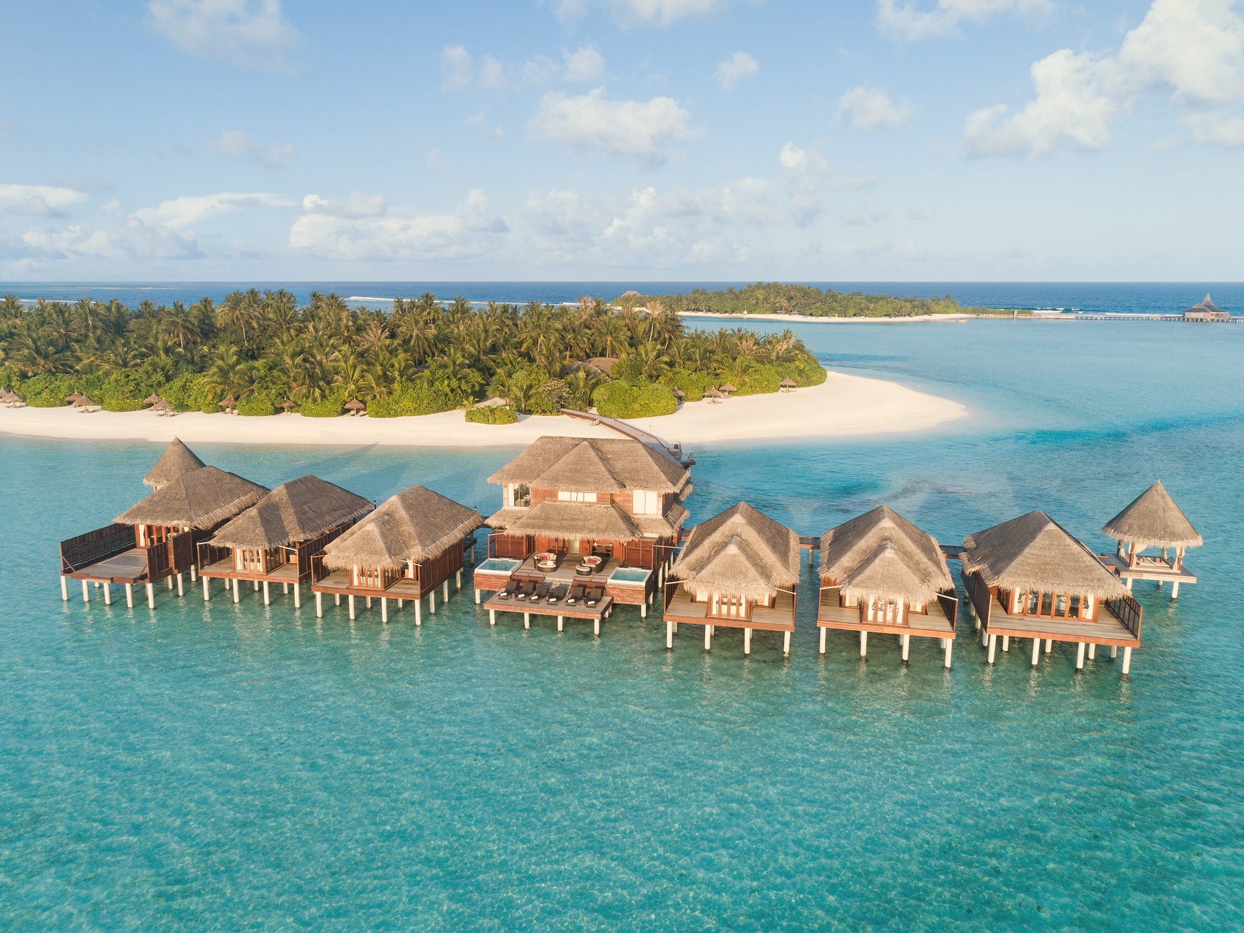 Dhigu Island from above, the resort spread across its own landmass in South Malé Atoll with the lagoon visible on all sides.