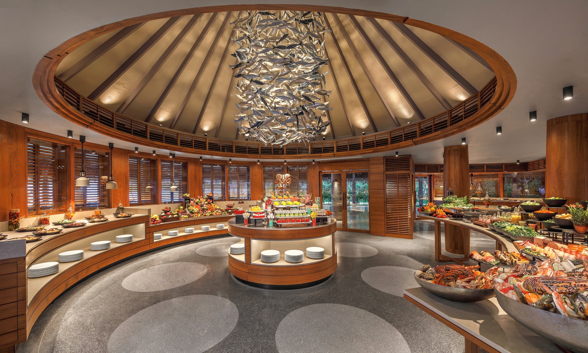 Dining at one of the resort's waterfront restaurants, tables set at the lagoon edge as the light drops.
