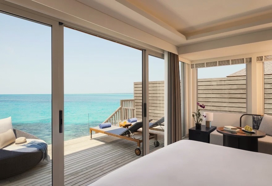 The lagoon edge from inside an overwater villa. The water colour in Baa Atoll shifts through the day as the light changes.