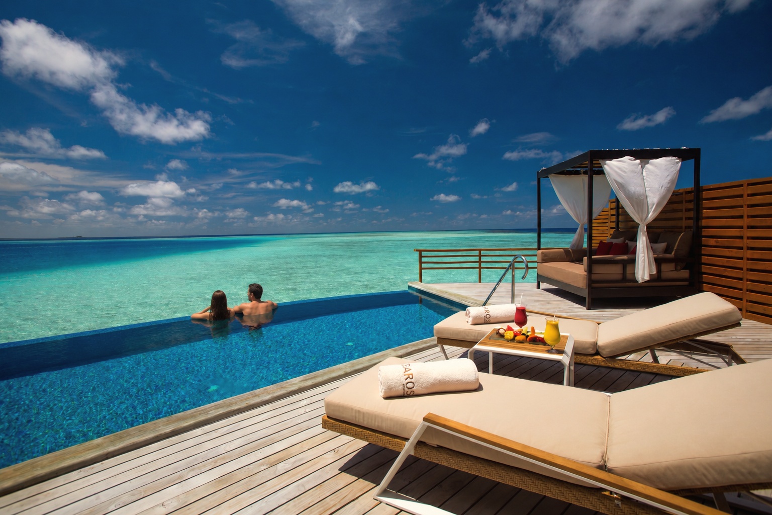 A Water Pool Villa from the deck. The overwater villas at Baros extend directly above the lagoon, with steps down to the water from the private pool terrace.