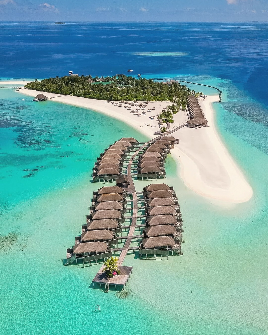 Moofushi from above. A single island in South Ari Atoll, the overwater villas extending from the island's edge into the lagoon.