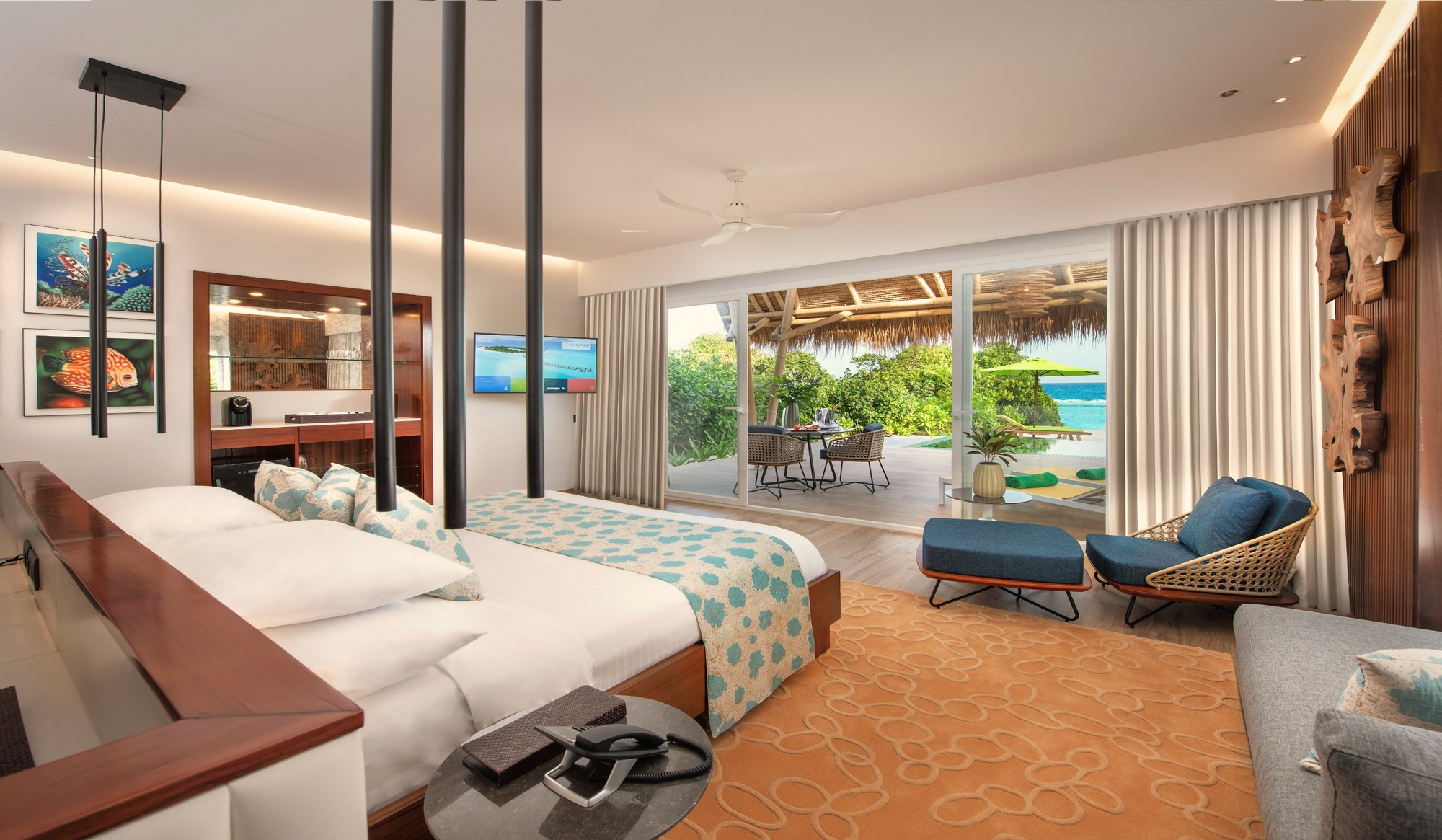 The interior of a beach pool villa. Private pool in the foreground, direct beach access beyond the garden.