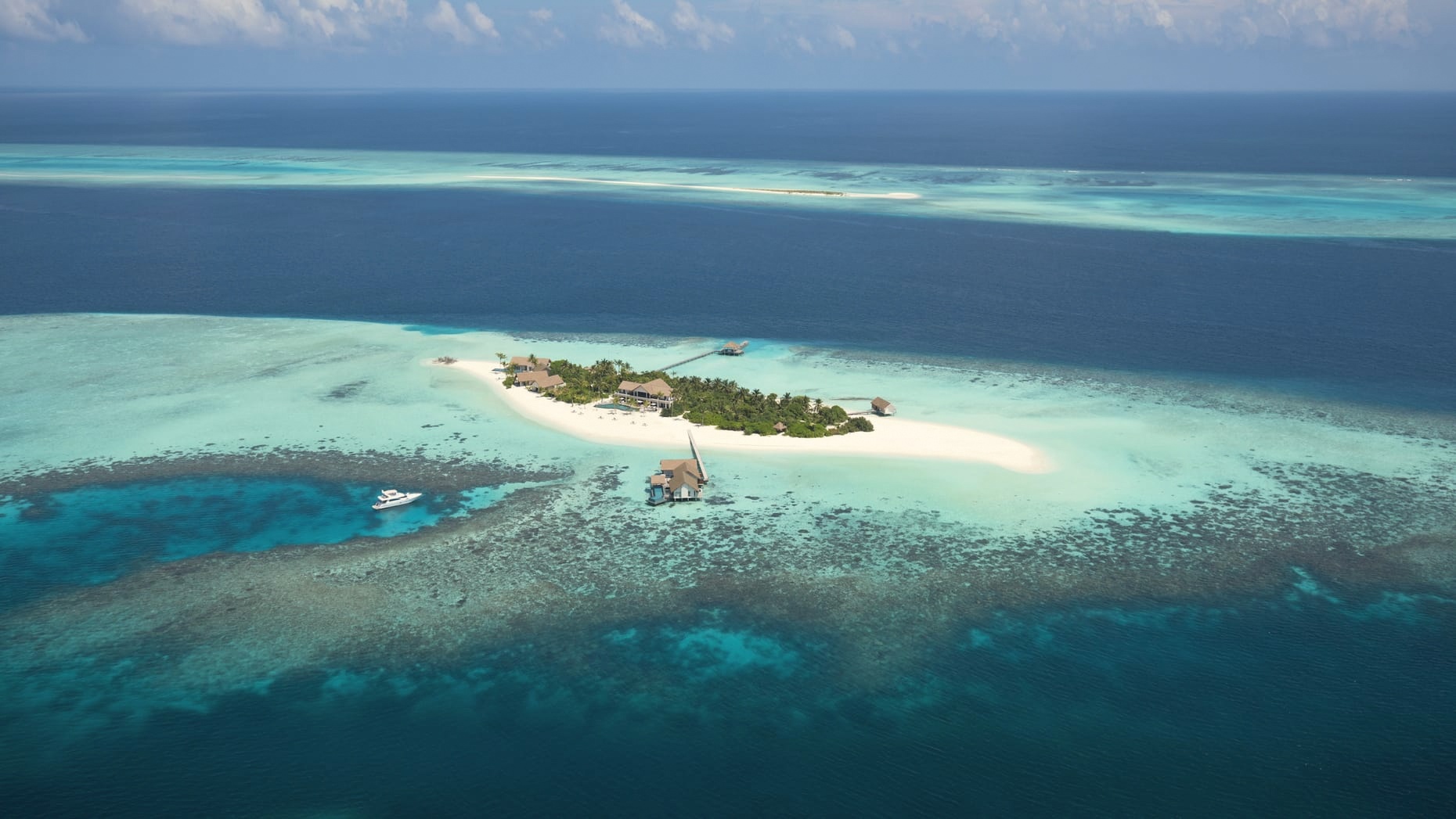 Kuda Huraa from above. The compact North Malé island reachable by twenty-five-minute speedboat, the operationally simplest Four Seasons in the country.