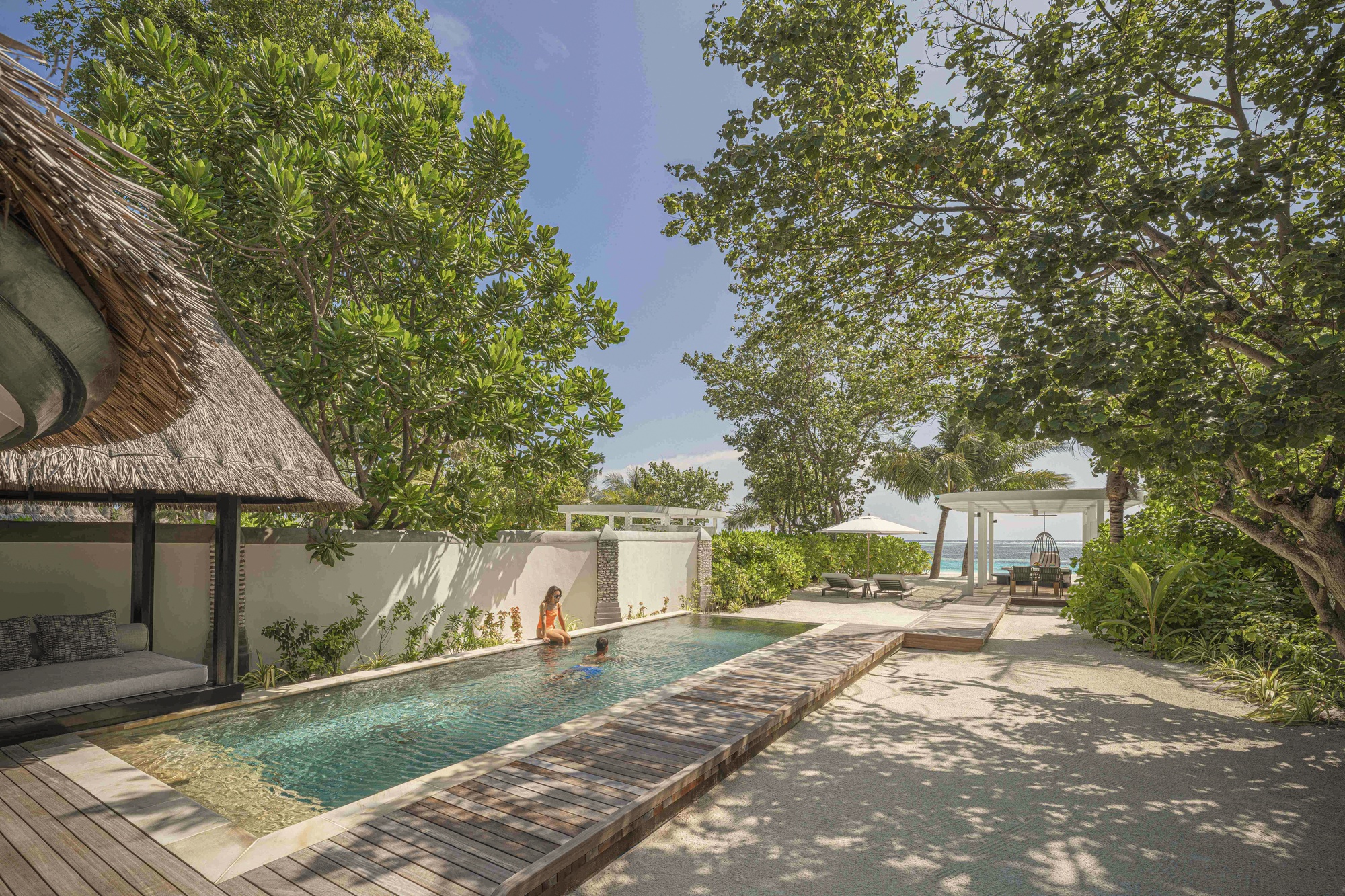 Beach pavilion deck. Kuda Huraa's signature beach configuration, well-finished within the operational simplicity of the speedboat-only access.