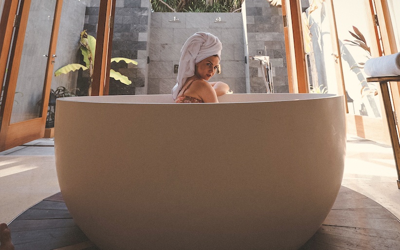 The spa treatment room. Natural materials, a single bed, and the sound of the ocean through the open wall.