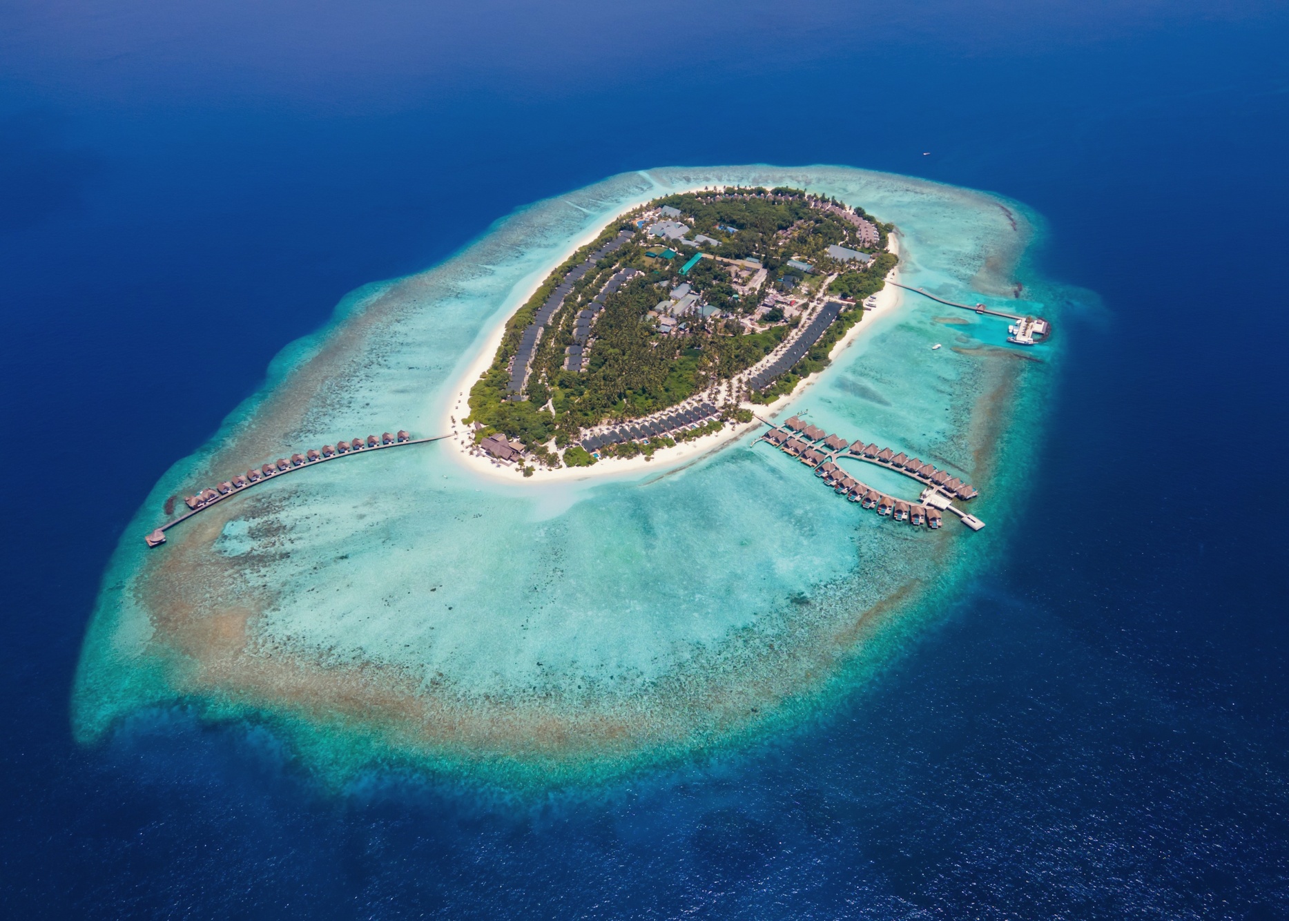 Furaveri from above, a single island in Raa Atoll with the reef visible through the water on all sides.