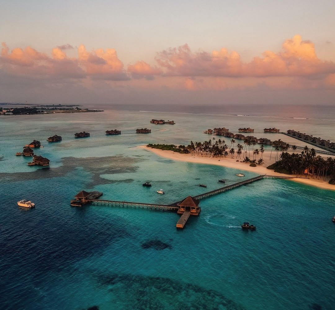 Lankanfushi from above. The thatched overwater Crusoe-style villas form Gili's defining aerial profile.