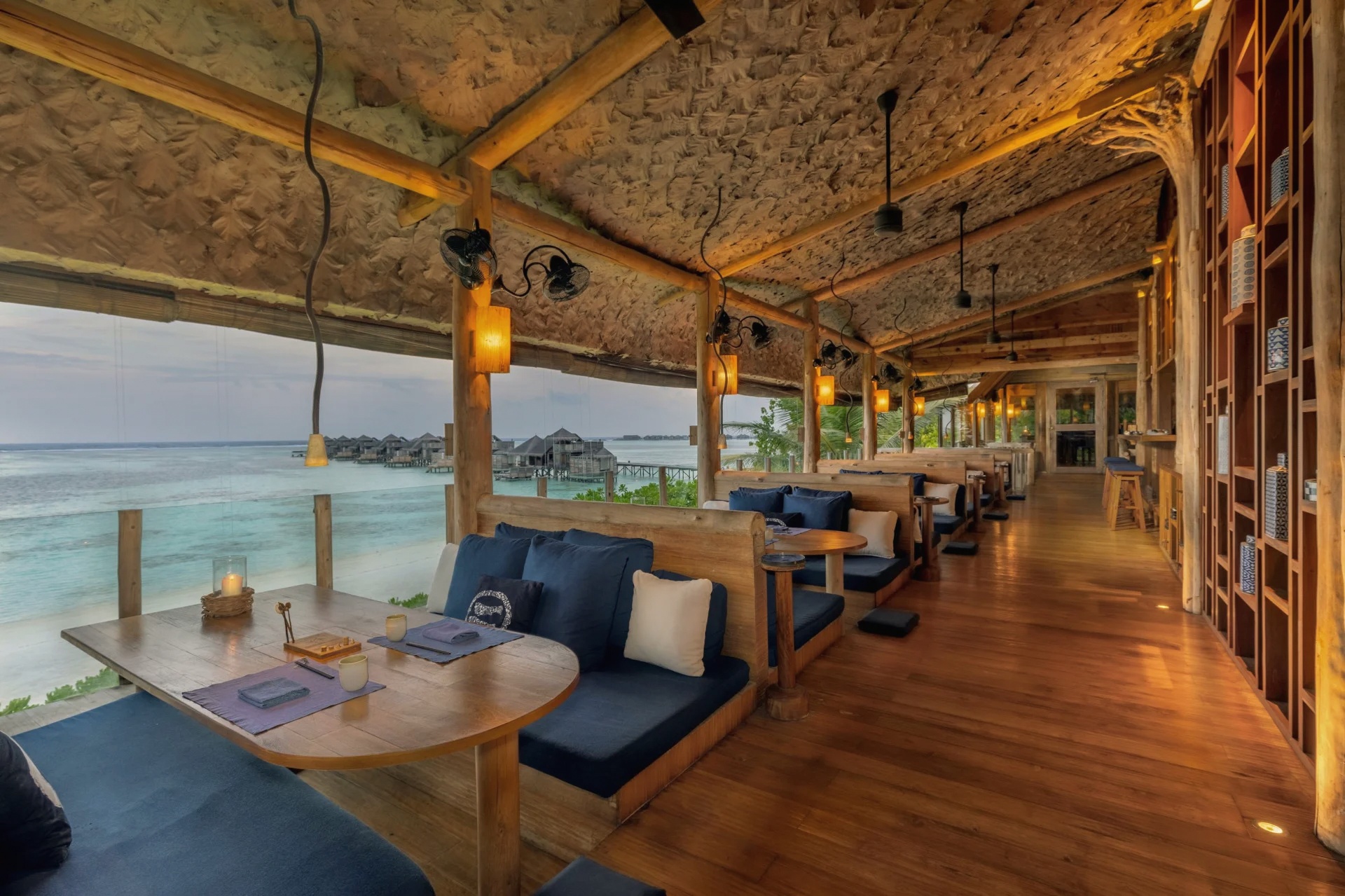 By the Sea. The treehouse bar set above the lagoon, accessible by walkway and one of the property's photographed evening moments.