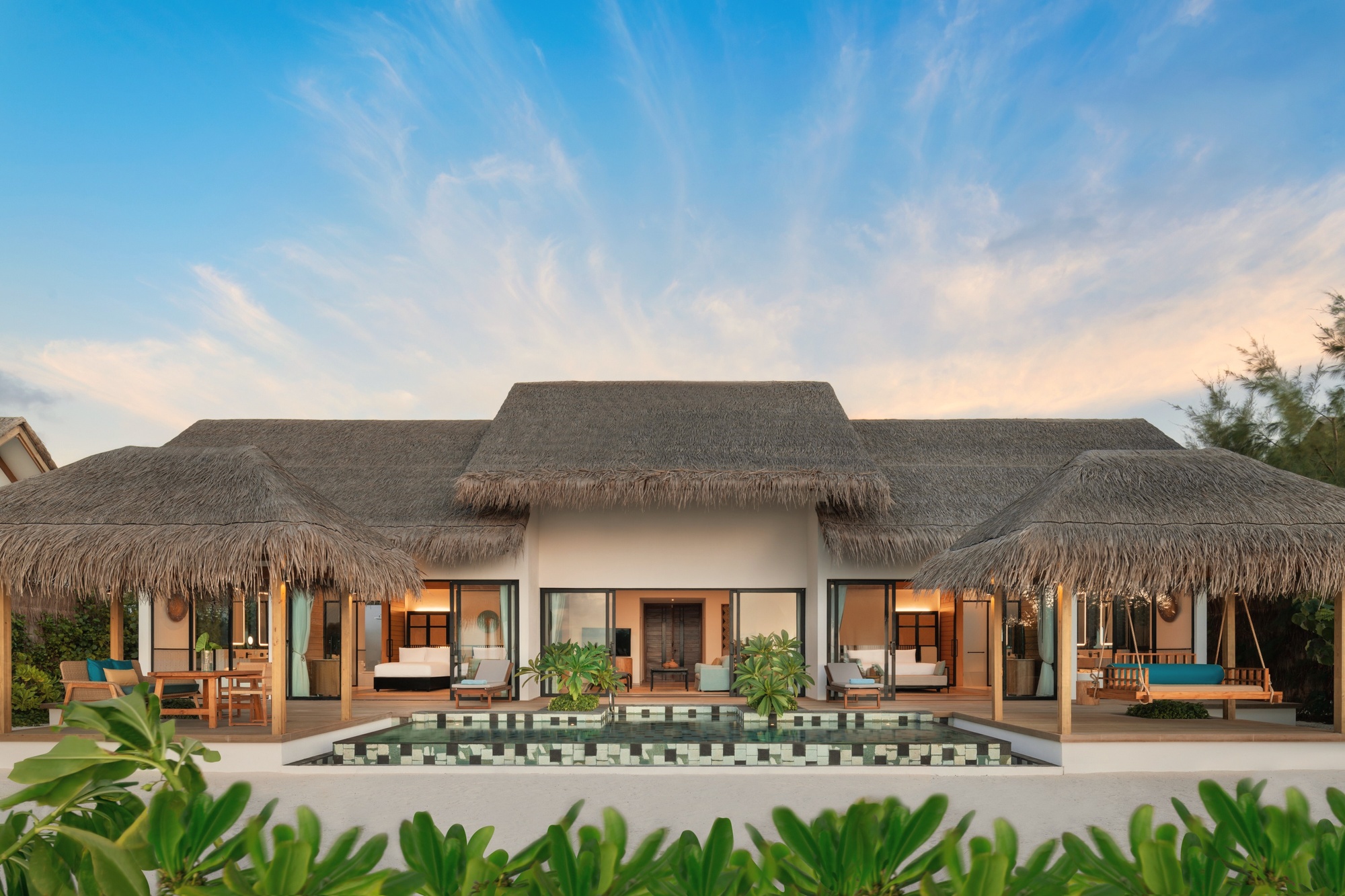 The beach villa garden. A private pool, sun deck, and direct beach access for guests who prefer the sand-and-sea configuration over overwater.