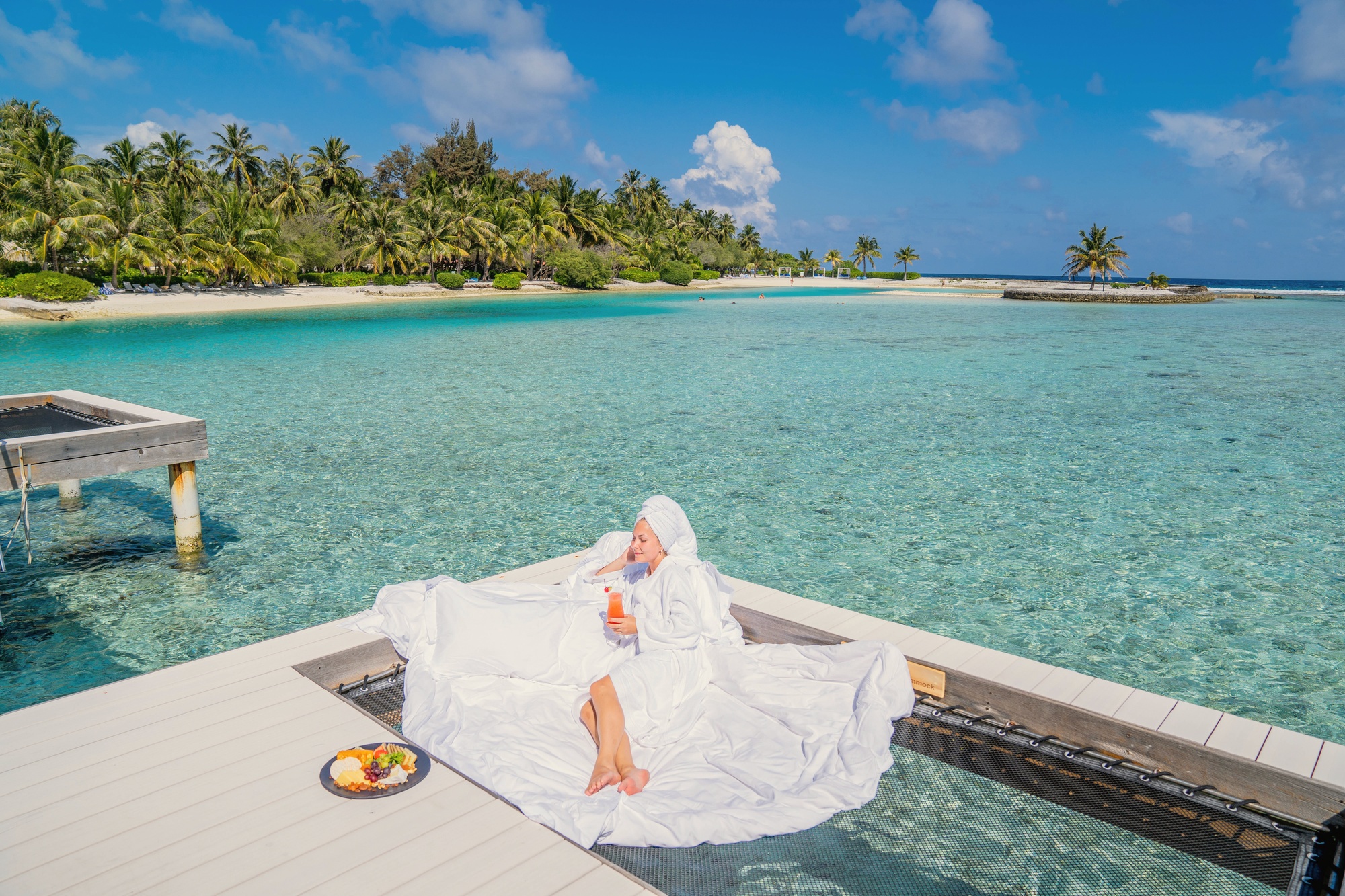 An overwater villa from the deck. The lagoon edge is its own room, and the South Malé water conditions are consistent for swimming directly from the villa.