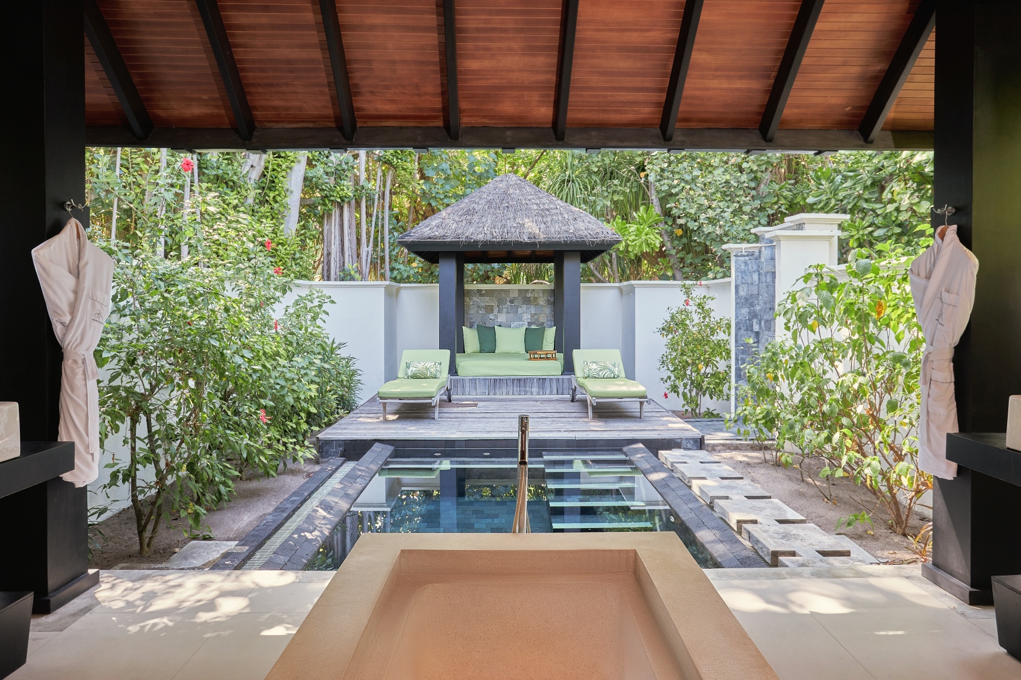 The interior of a beach pool villa. At 200 square metres, the configuration is generous, with the private pool opening directly onto the beach.