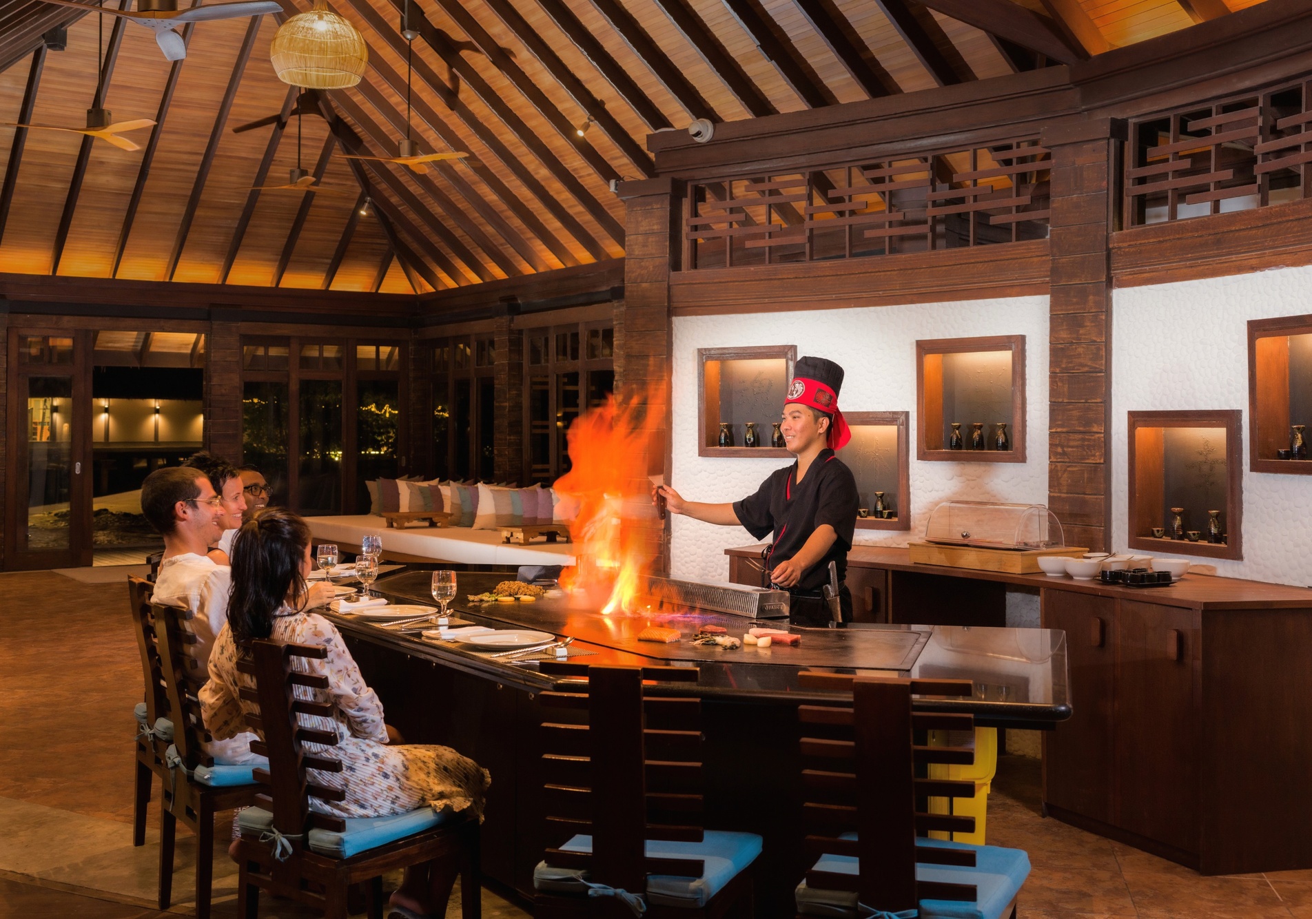 A dining terrace over the water. The resort's restaurant programme serves guests across multiple venues on the island.