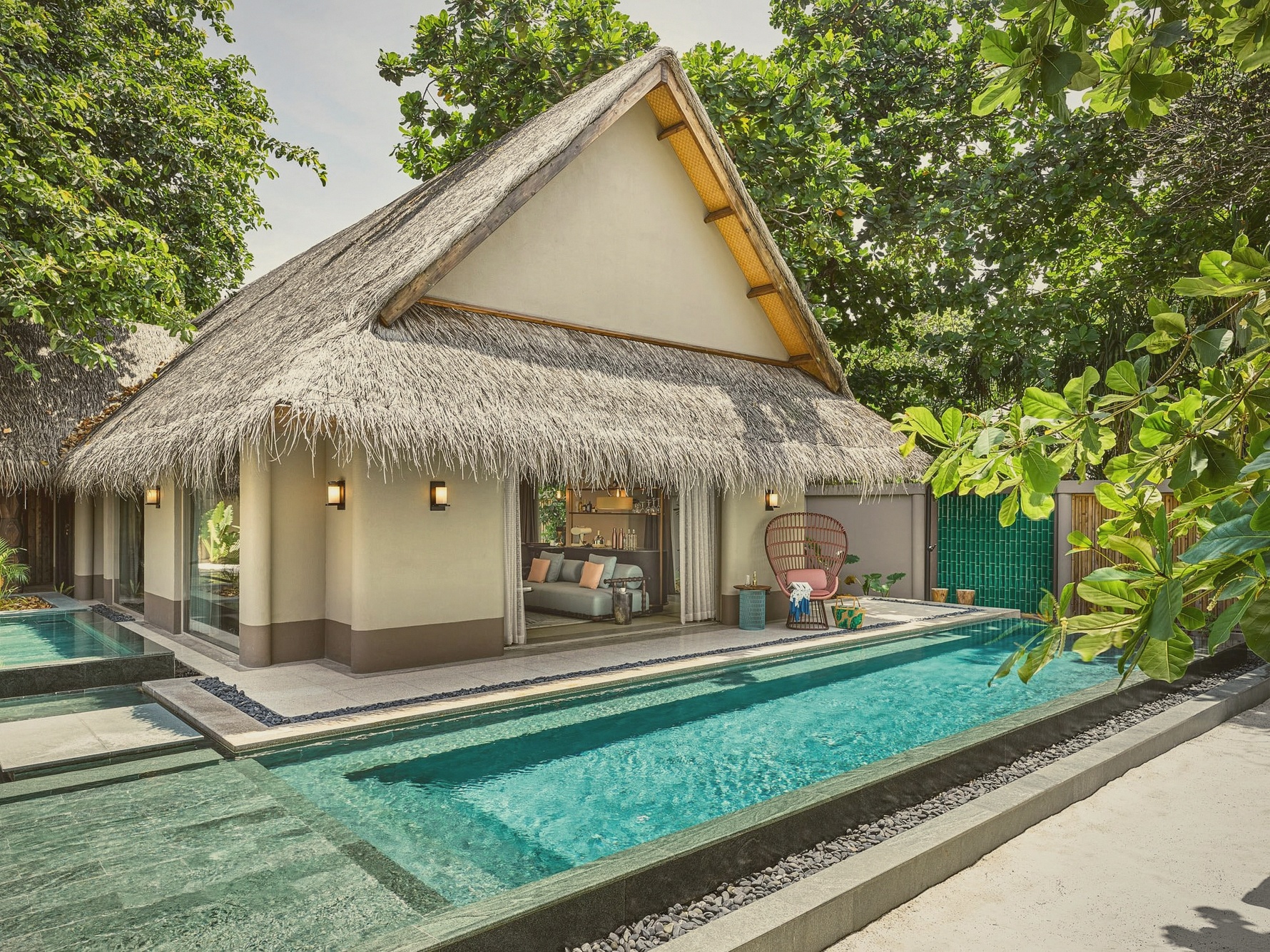 Beach pool villa interior. JOALI's design language carried into the residential spaces, distinct from generic luxury vocabulary.