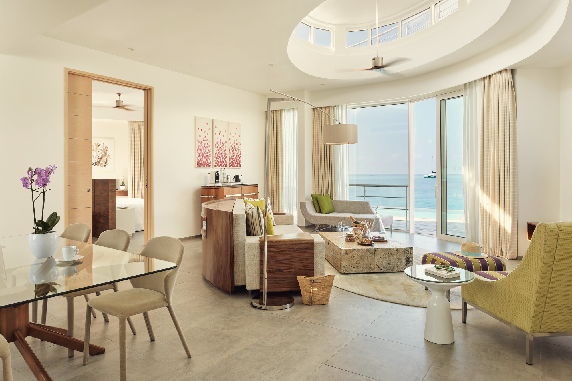 The open-air rooftop terrace on a grand lagoon villa. Set for a private dinner, with the lagoon and horizon visible on three sides.
