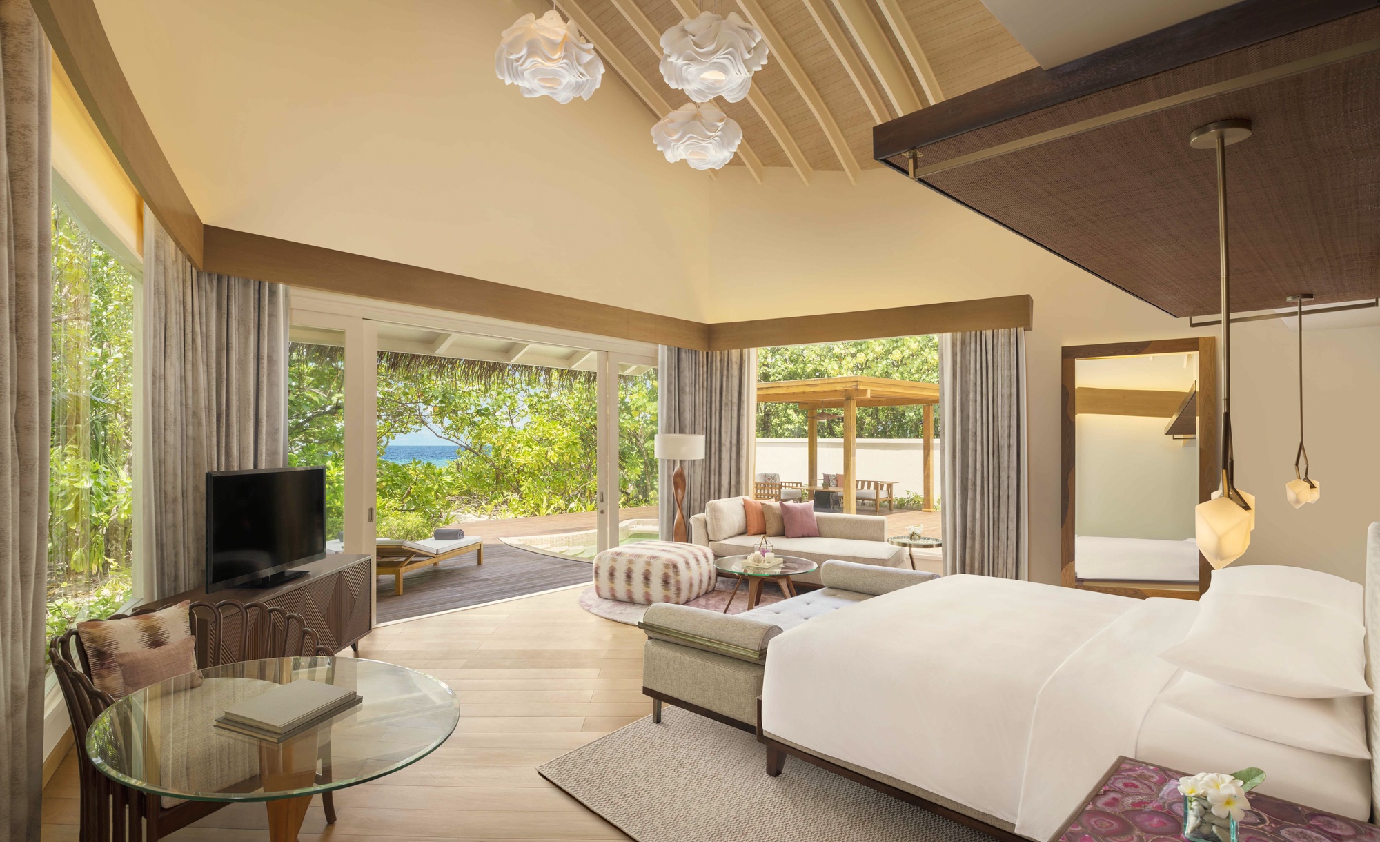 The interior of a beach pool villa. Private pool, direct sand access, and the kind of finish that holds up across a longer stay.