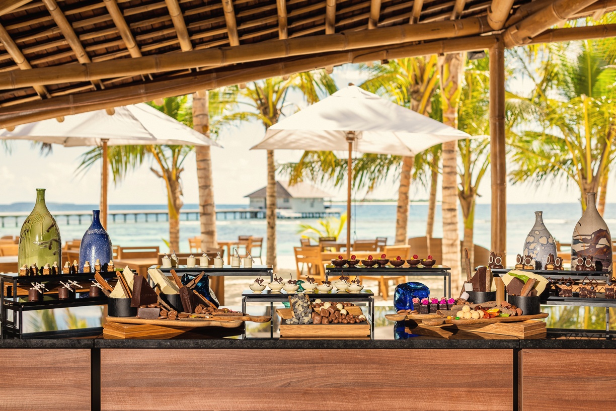 Dining at the water's edge. The main restaurant sits close enough to the lagoon that the light changes with the tide.