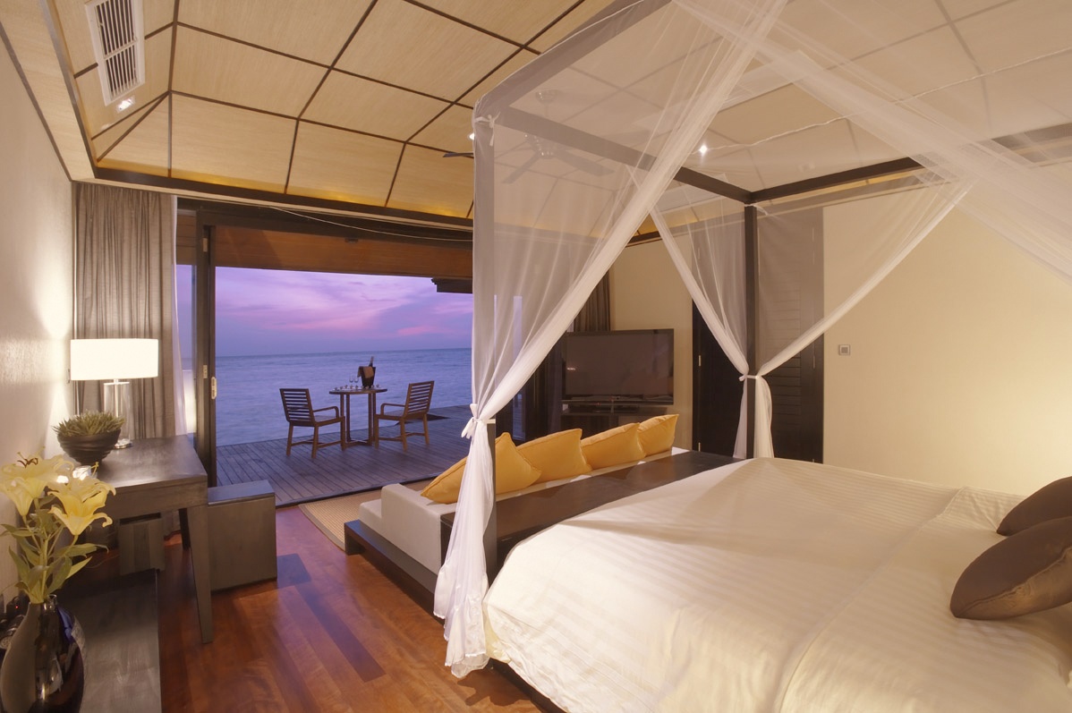 The villa interior looking out to the lagoon. Finishes are at the level the all-inclusive rate suggests, without the trade-off in quality that some full-board resorts accept.