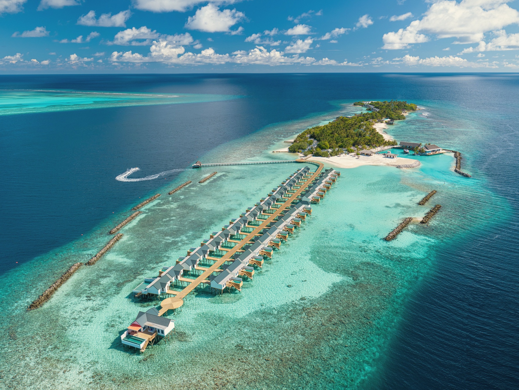 Helengeli from above. A compact island in North Malé Atoll, the channel visible on the eastern edge where the serious diving begins.