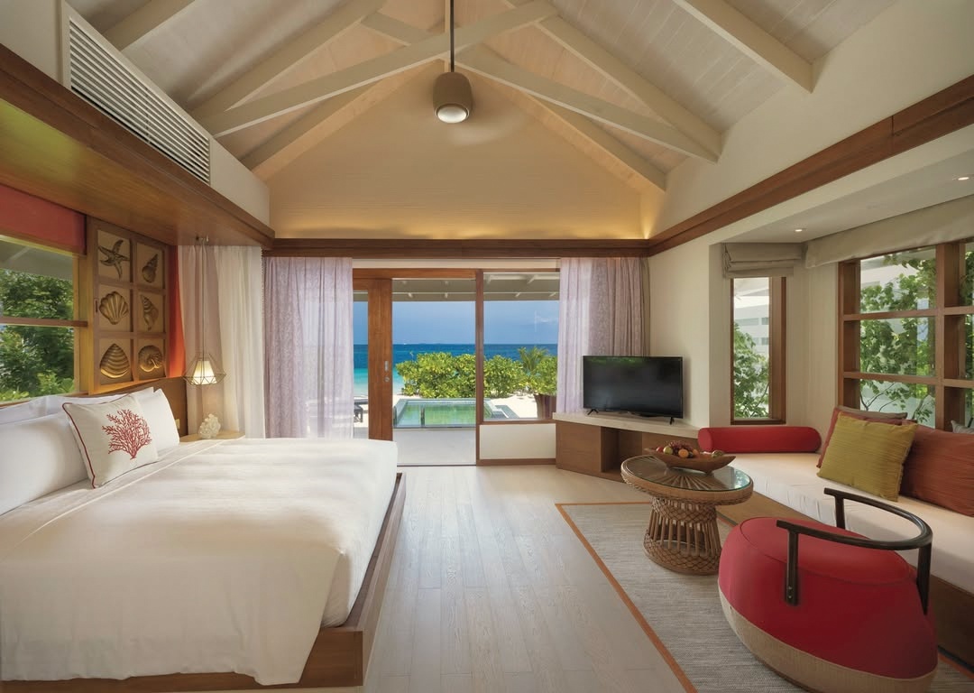 The beach villa garden. For guests who prefer direct sand access over the overwater configuration, the beach pool villas offer a private pool and a short walk to the water.