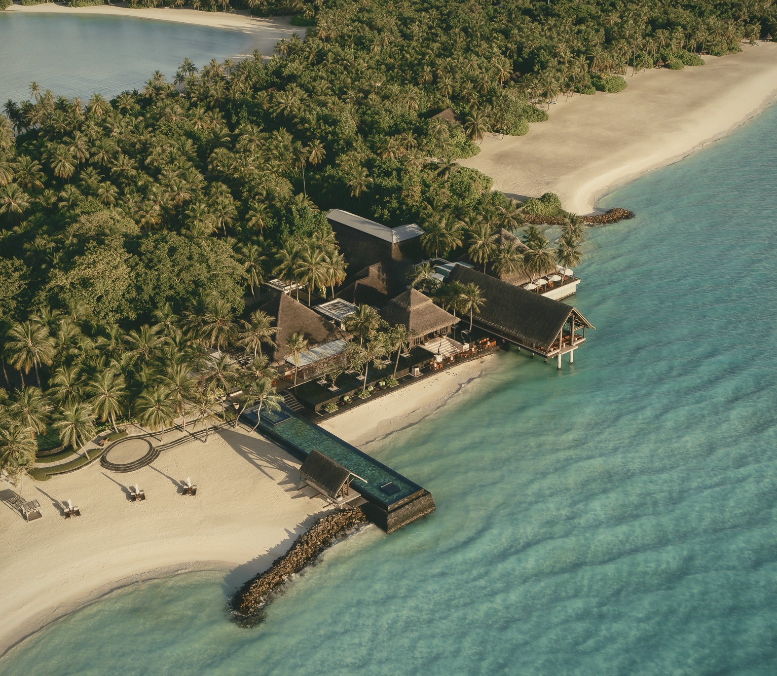 Reethi Rah's twelve-bay shoreline from above. The largest island footprint among the OV portfolio's North Malé properties.