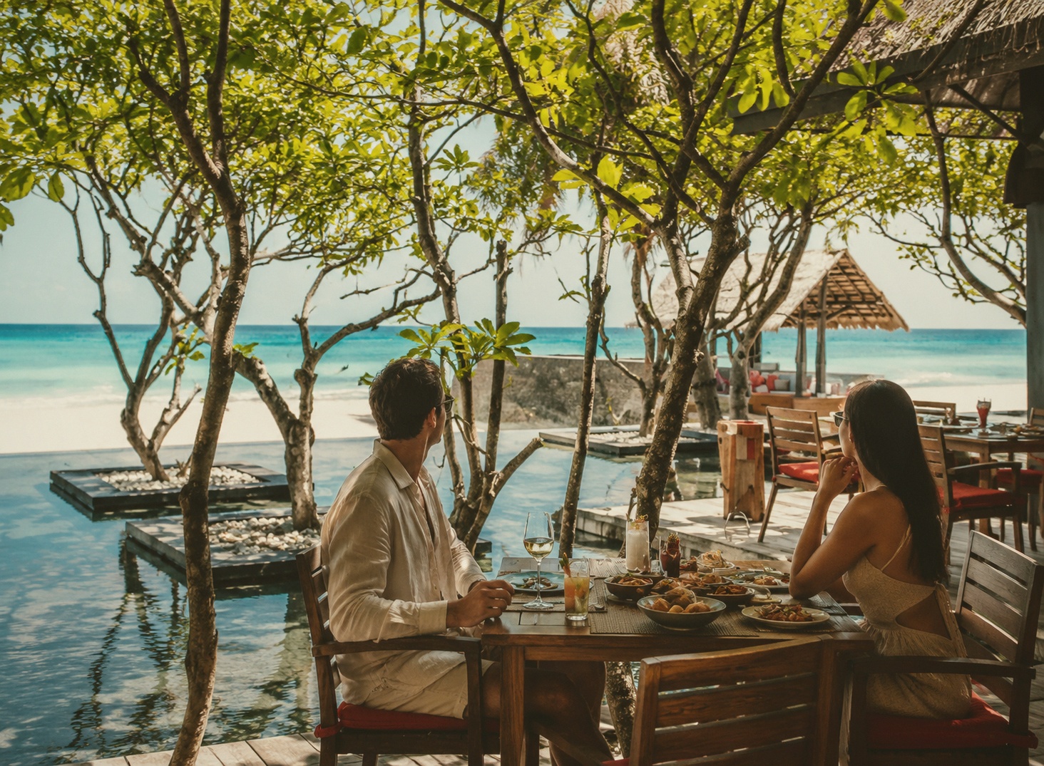 The sunset cocktail bar. One&Only's most photographed evening space, set on the western shoreline.