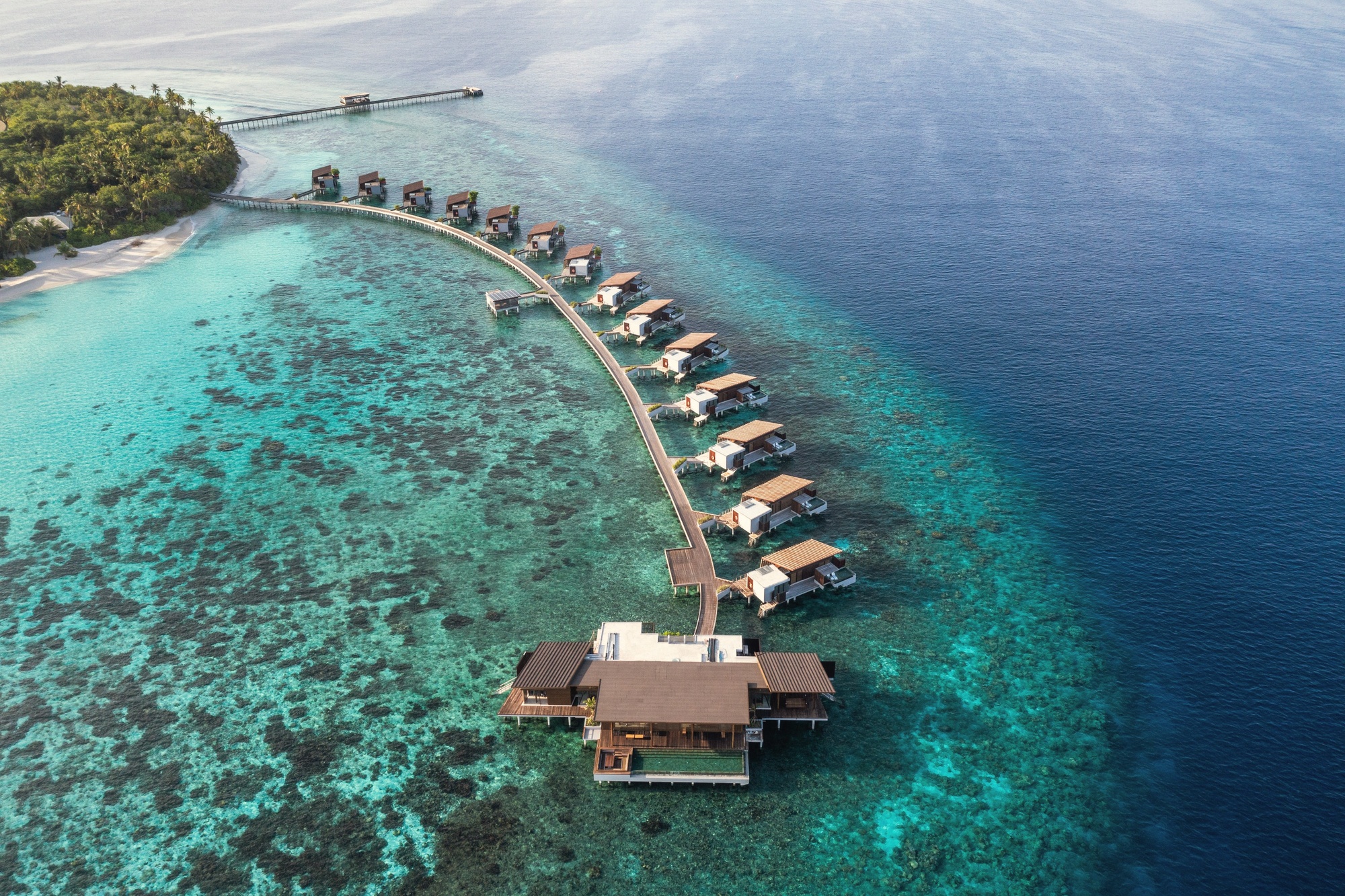 Hadahaa from above. A single island in Gaafu Alifu Atoll, the resort occupying the full landmass with the house reef visible at the waterline.