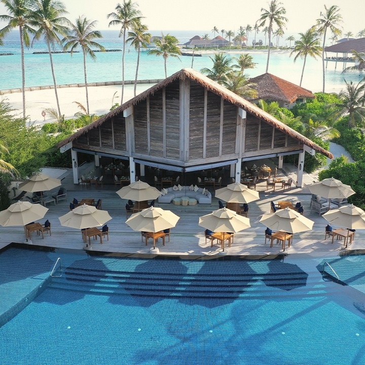 A dining terrace at the water's edge. The South Ari sunset is a reliable event; the west-facing tables are the ones to request.