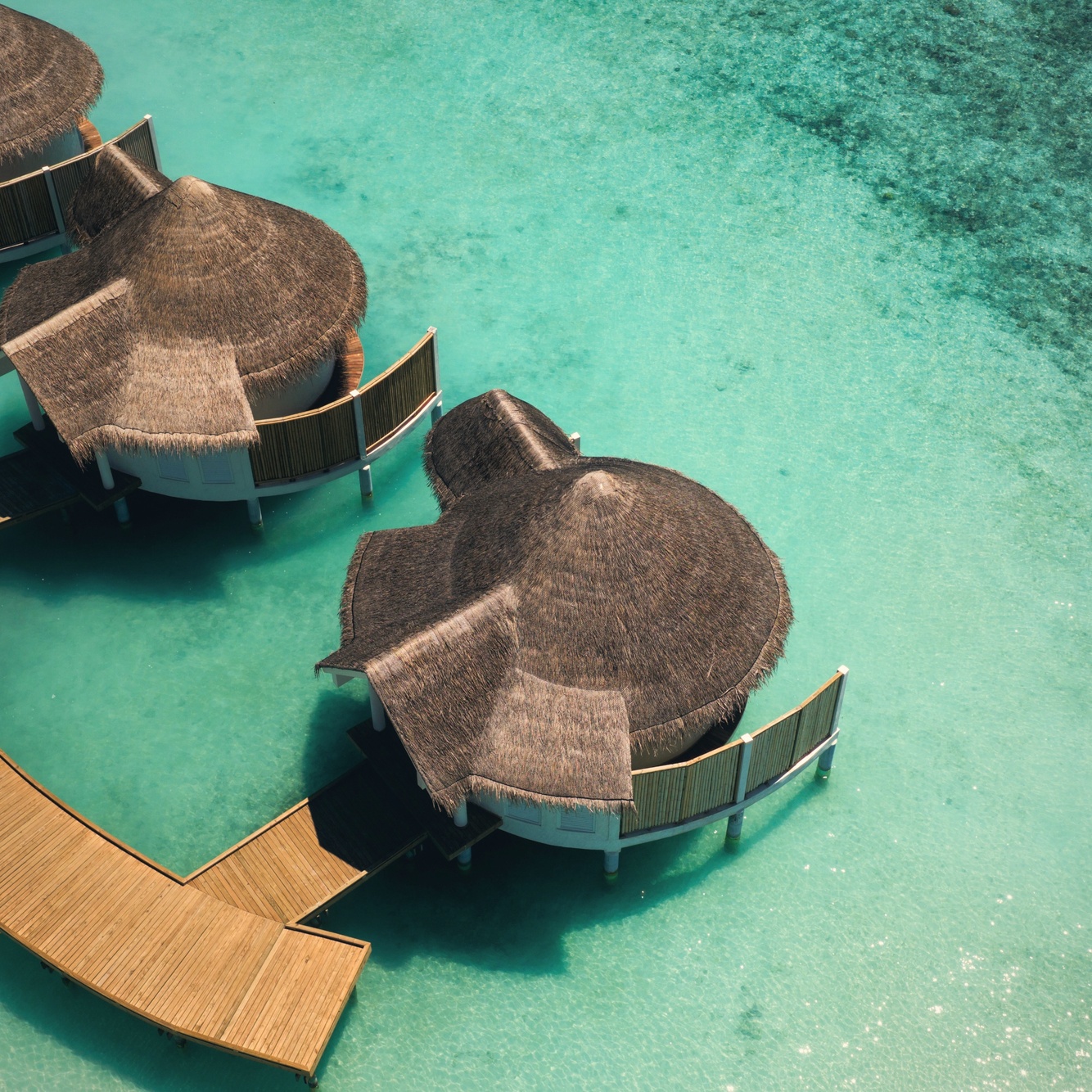 Rah Gili from above. The resort occupies its own private island, with overwater and beach villas arranged around a central lagoon.