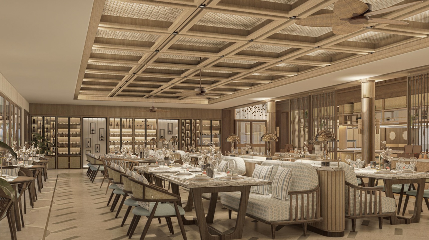 The resort's main dining venue at the water's edge. Tables are set for the evening with the lagoon as the backdrop.