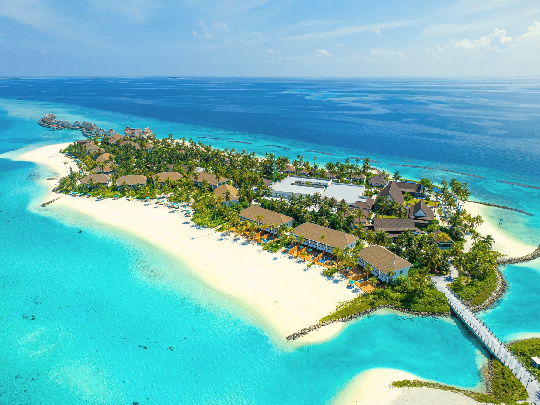 SAii Lagoon from above, the Crossroads Maldives platform visible across the South Malé lagoon. The development sits within speedboat range of Velana International Airport.