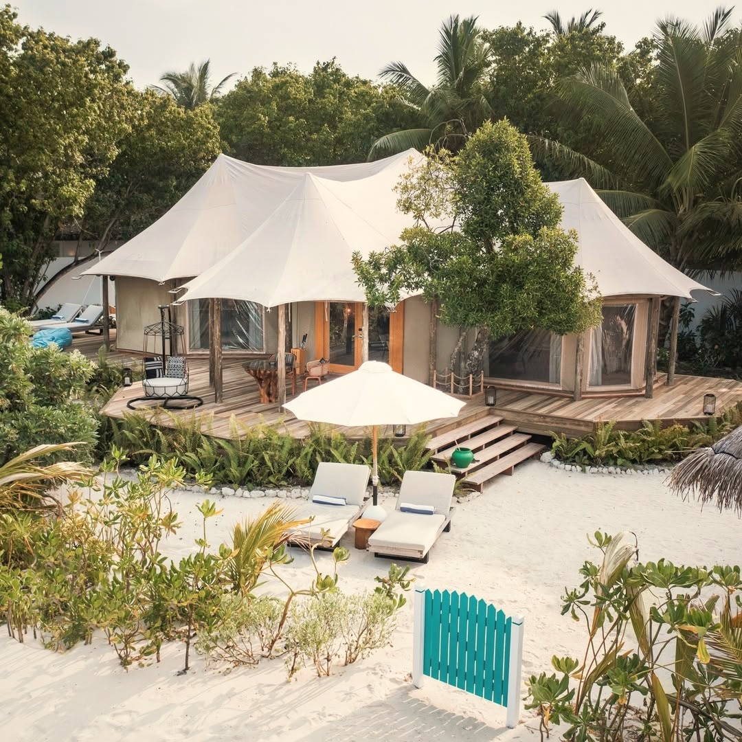 A Safari Tented Villa at dusk. Tented accommodation at this standard is unusual in the Maldives, and the format delivers a different spatial experience from a conventional villa.