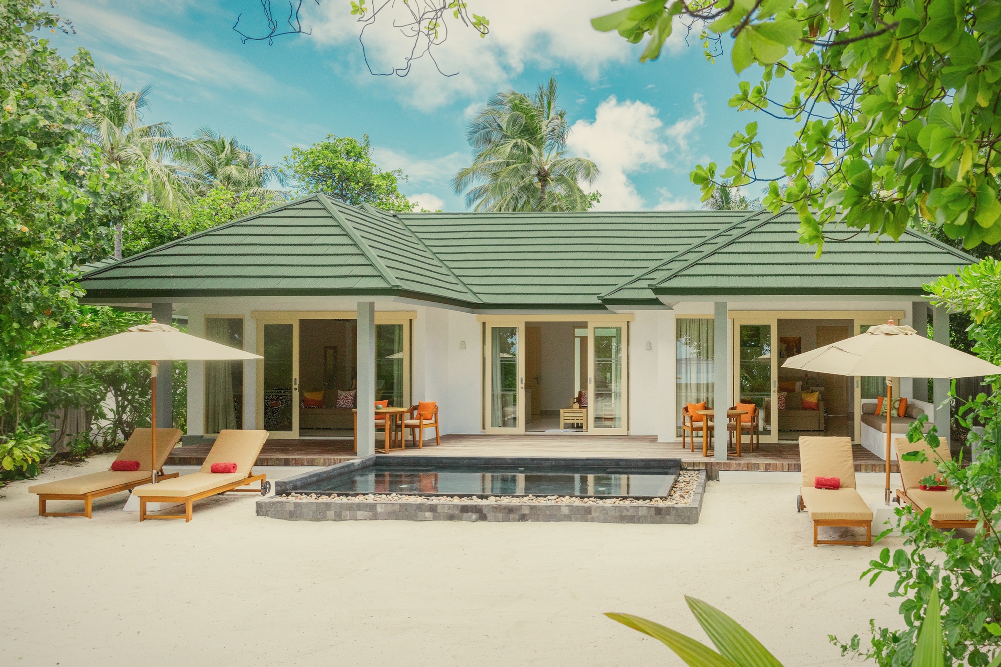 Inside one of the beach pool villas. The pool sits between the villa and the beach, with direct sand access beyond the garden boundary.