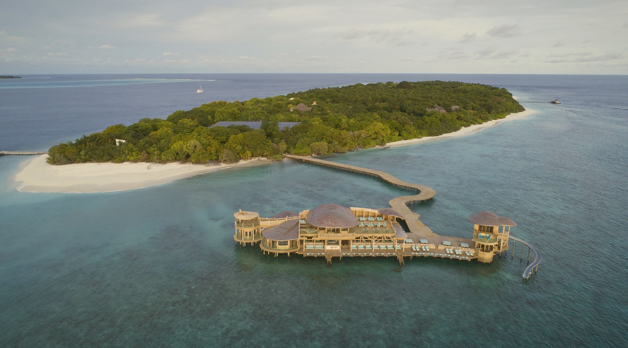 Out of the Blue overwater dining. Six restaurants suspended above the lagoon and connected by walkways, a defining Soneva architectural moment.