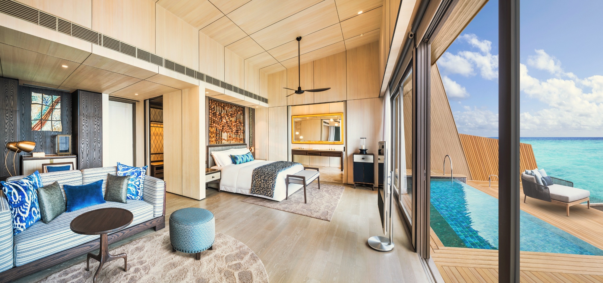 The villa interior. St. Regis-standard finishes, generous proportions, and a private pool at the lagoon edge.