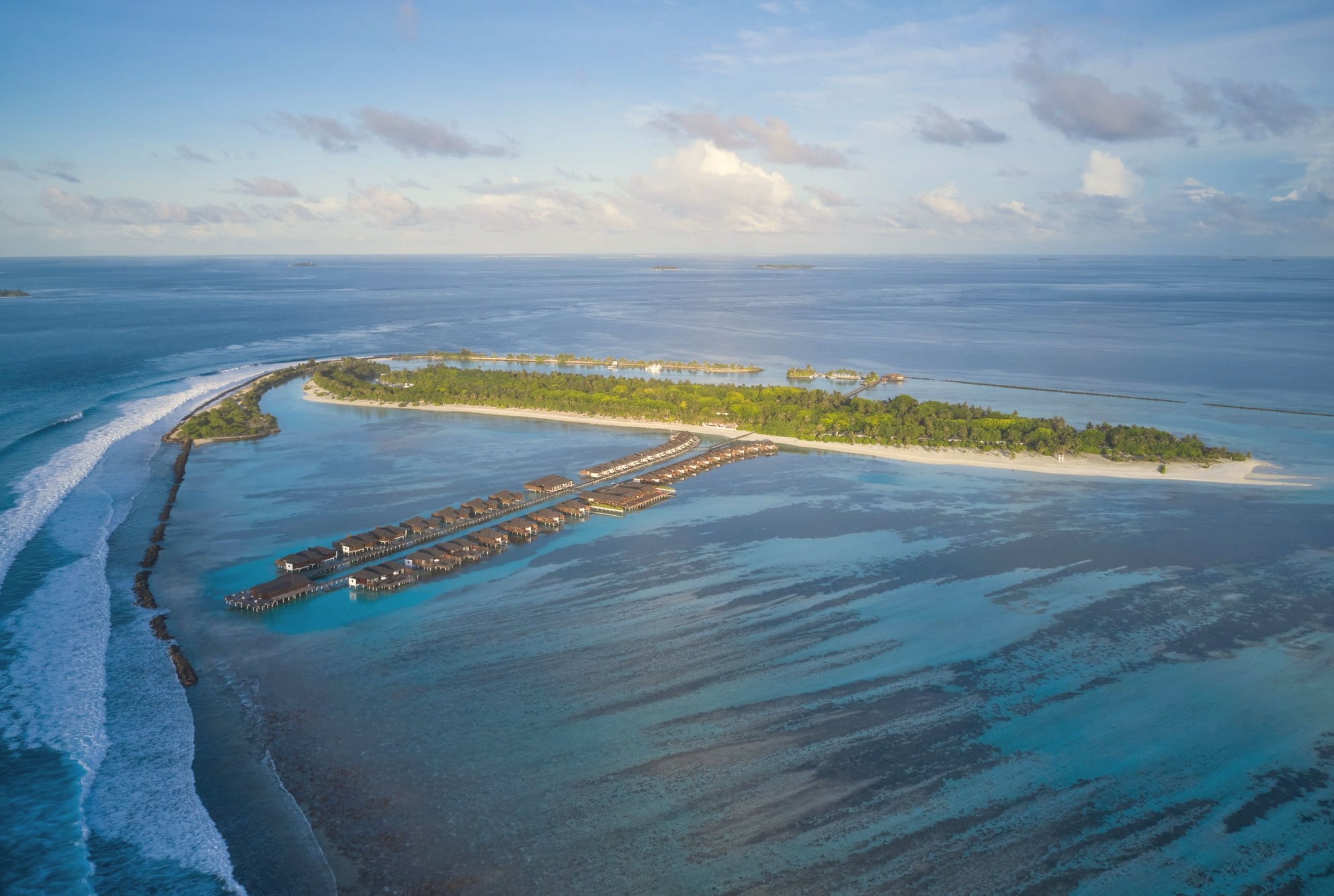 Paradise Island from above. Villa Nautica occupies its own island in North Malé Atoll, the resort's facilities visible across the full length of the property.