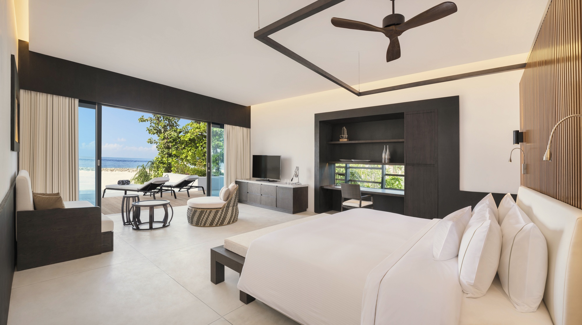 The villa interior looking out toward the water. The Westin Heavenly Bed configuration and the lagoon view are the two things guests mention first.